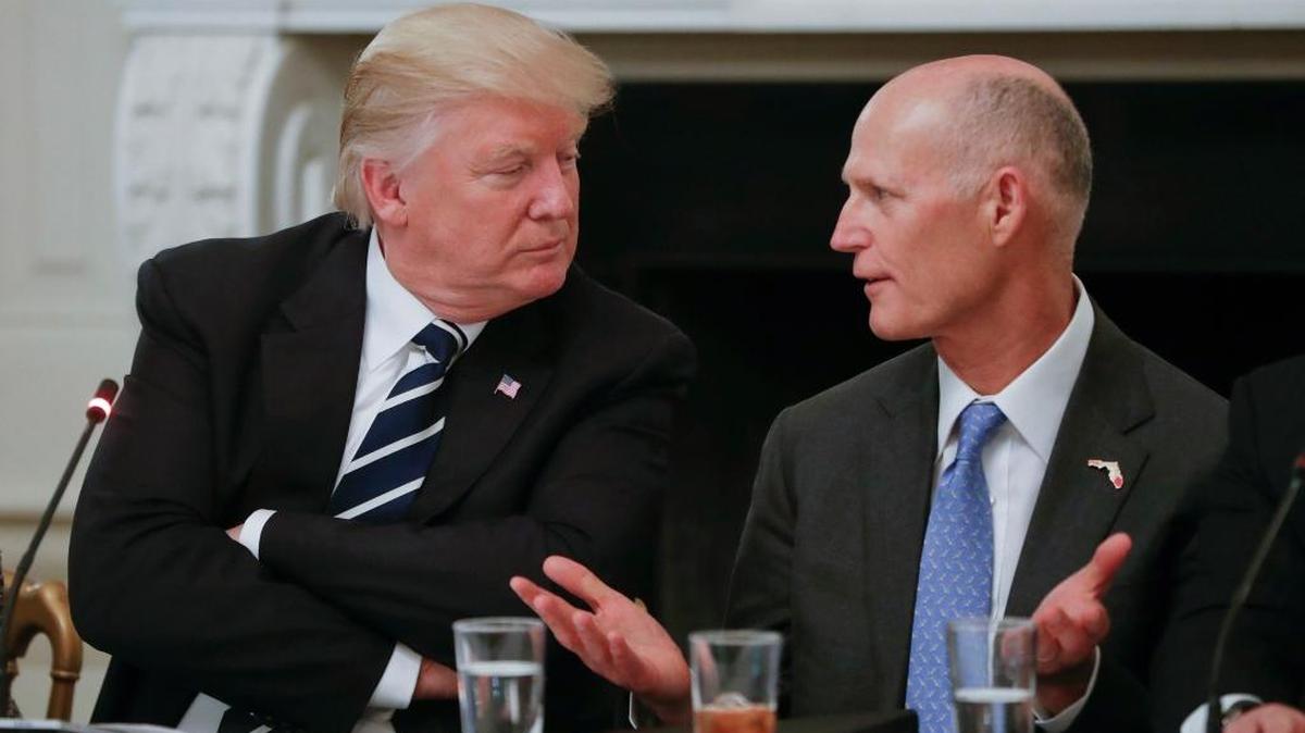 President Donald Trump listens to Florida Gov. Rick Scott, right, during a meeting with U.S. mayors and governors at the White House in Washington on June 8, 2017.