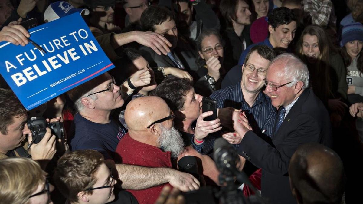 Senator Bernie Sanders greets supporters after speaking during a caucus night party in Des Moines, Iowa, on Monday.
