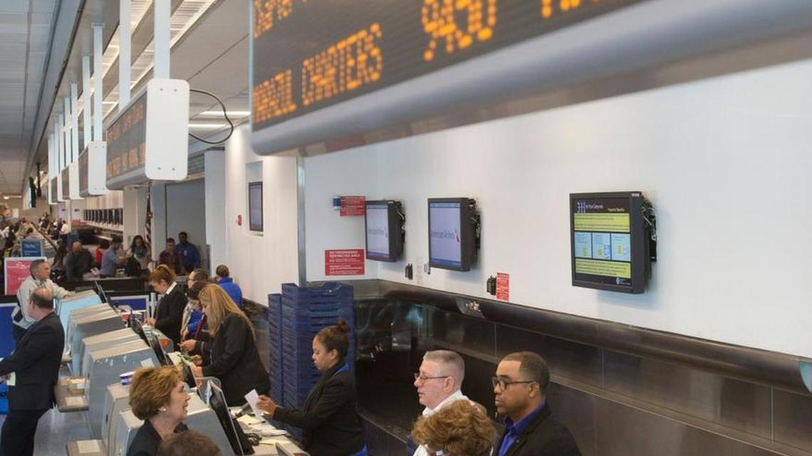 Travelers on charter flights from Miami to Havana line up at the ticket counter at Miami International Airport.