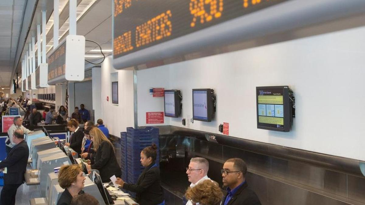 Travelers on charter flights from Miami to Havana line up at the ticket counter at Miami International Airport.