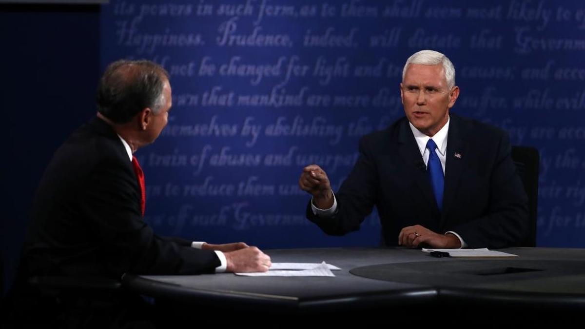 Mike Pence, 2016 Republican vice presidential nominee, right, speaks as Tim Kaine, 2016 Democratic vice presidential nominee, listens during the vice presidential debate at Longwood University in Farmville, Virginia, on Tuesday