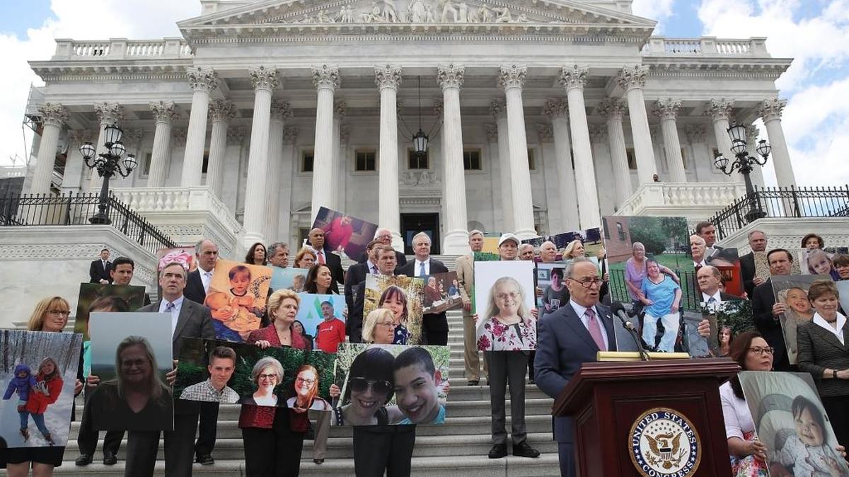 Senate Minority Leader Chuck Schumer (D-NY) speaks while flanked by Senate Democrats holding photos of people who would lose their health coverage under the Senate Republicans healthcare bill during a press conference at the U.S. Capitol on June 27, 2017 in Washington, DC.