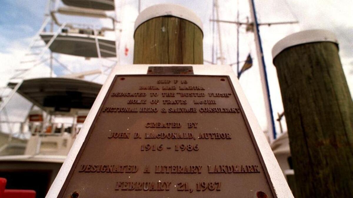 Plaque at Slip F18, the location where fictional detective Travis McGee docked his houseboat, commemorates the works of author John D. McDonald.