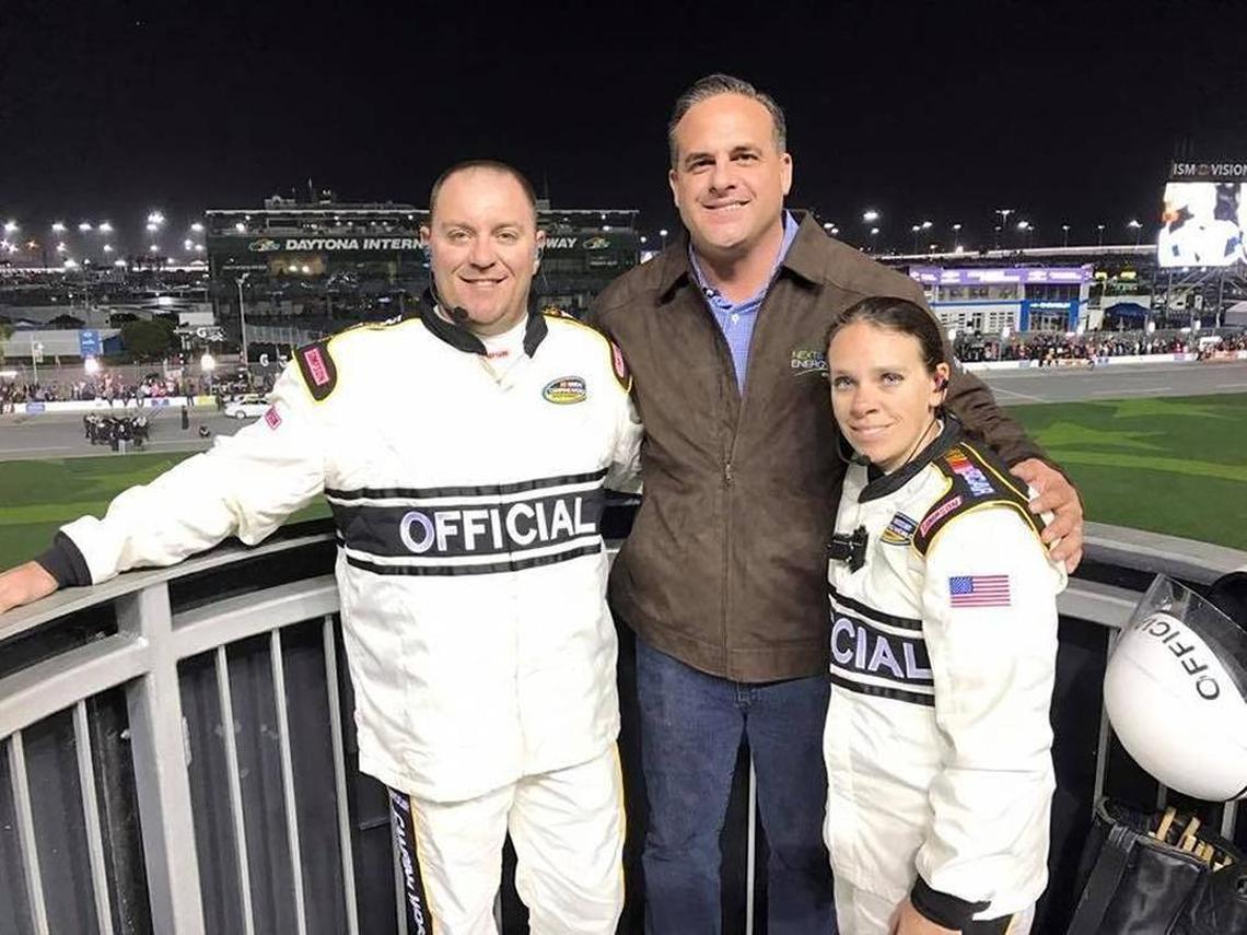 Florida Sen. Frank Artiles, chairman of the Senate Communications, Energy and Public Utilities Committee, poses with two race officials at Daytona Beach International Speedway on Feb. 24. NextEra sponsored the Friday night truck race. Artiles put on the sponsor’s jacket and waved the green flag.