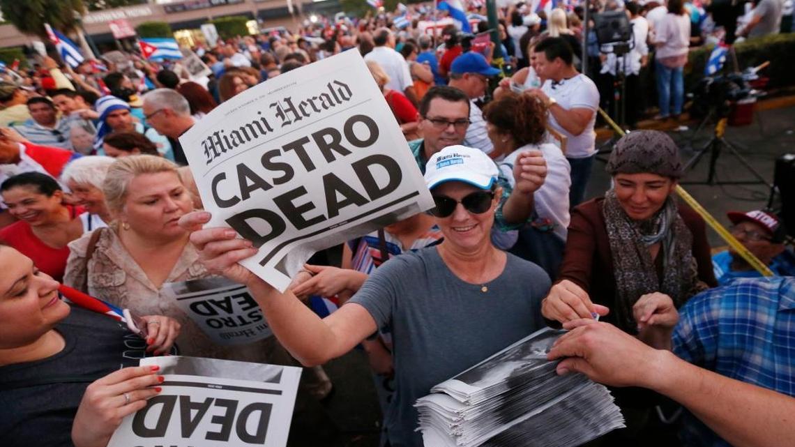 Alexandra Villoch, president publisher of the Miami Herald Media Company, hands out a posters marking Fidel Castro’s death with the headline "Castro Dead," in front of the Versailles Restaurant in the Little Havana neighborhood of Miami as members of the Cuban community react to the death of Fidel Castro, Saturday, Nov. 26, 2016. Castro, who led a rebel army to improbable victory in Cuba, embraced Soviet-style communism and defied the power of 10 U.S. presidents during his half century rule, died at age 90.
