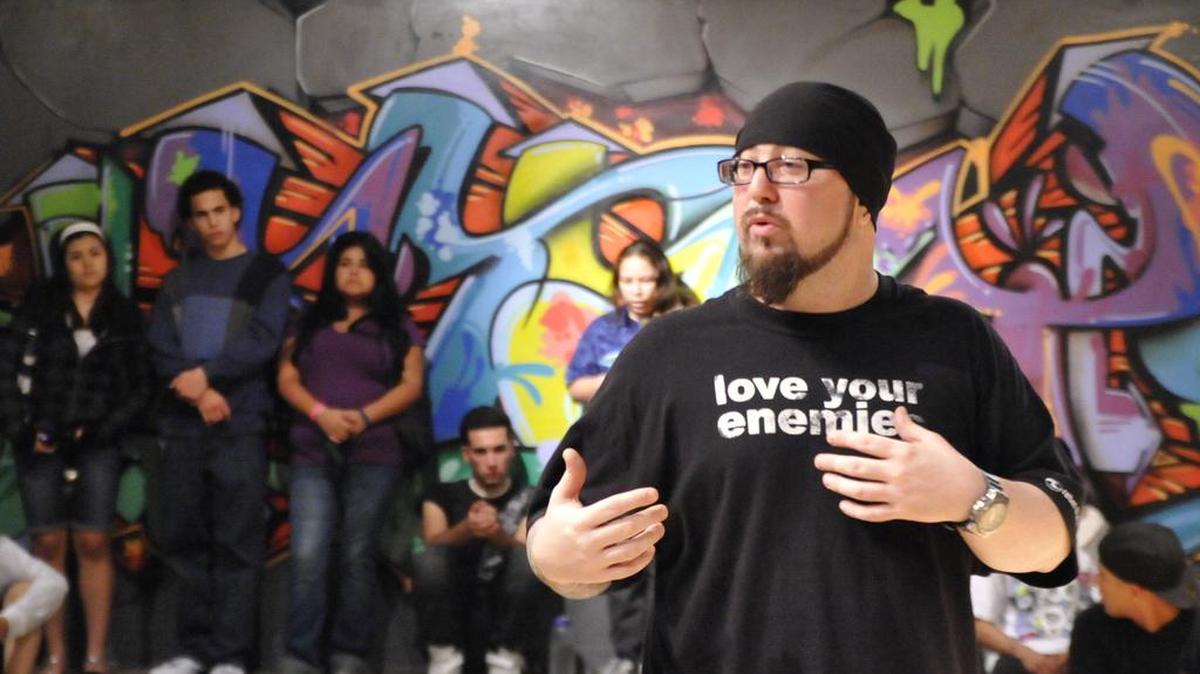 Joel Stigale, director of Catalyst Hip-Hop, asks attendees of his biweekly break-dancing competition at First Presbyterian Church of Miami of Miami Springs, “Are you taking what [Jesus] did for granted?” in this Saturday, Dec. 27, 2008, photo. Stigale gave local youths a place to practice their oft-marginalized talents, keeping them off the streets.