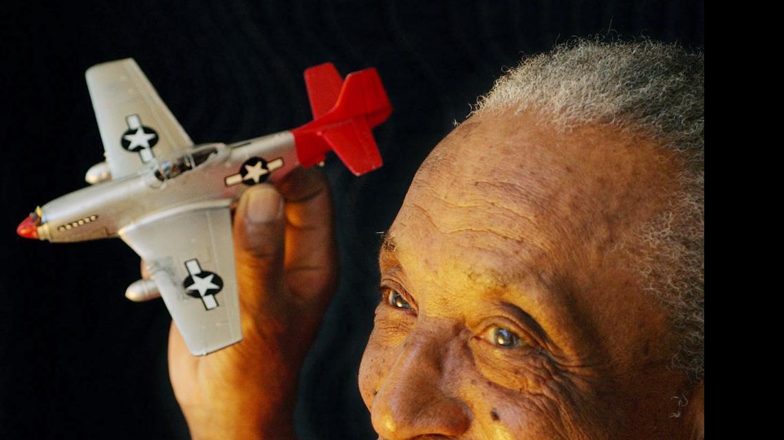 
TUSKEGEE AIRMEN HONOREE: Retired Air Force Lt. Col. Eldridge Williams, seen here in 2011, was one of the celebrated Tuskegee Airmen. He holds a model of a P-51 Mustang used in World War II. Williams was a fitness and survival trainer during the war, trained fellow black pilots in the Airmen, and in 1949 he became a fighter intercept controller. After the war he joined Dade County Public Schools and helped integrate Miami schools.
