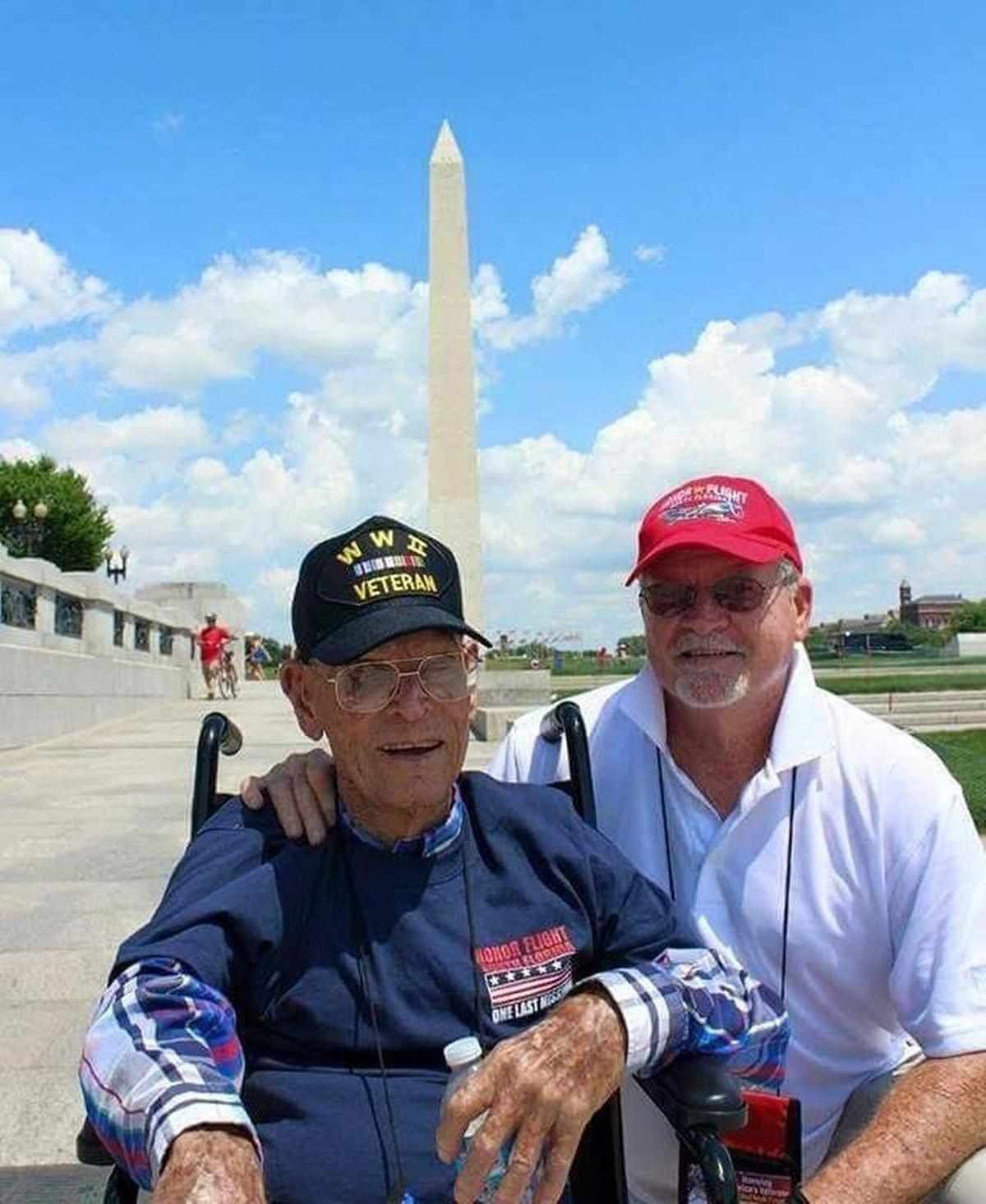 Clyde Roach (left) was on the Honor Flight for Memorial Day 2015. Roach, with his son Steve (right), was named honorary captain.