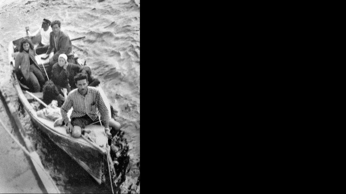 
EARLY RAFTER: Armando Rodriguez (front of boat), one of the first Cuban rafters in Florida, holds a rope thrown from the freighter Gulf Panther from Wilmington, Delaware, that rescued him and six others in the high seas as they escaped from Cuba in 1961. Rodriguez died at 96 in January 2014.
