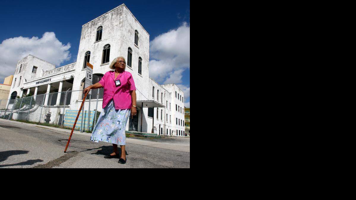 
COMMUNITY LEADER: The oldest Baptist church in the city of Miami, The First Baptist Church, has seen its better days. For some 20 years, longtime civic activist Georgia Ayers has used the building for an alternative program, burning through millions of dollars in grants to renovate the building. Ayers stands in front of the church on NW 60th Street, October 27, 2011.
