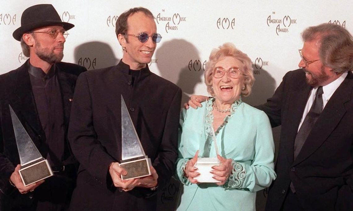 The Bee Gees share the honor of winning the 1997 International Award at the American Music Awards with their mom, Barbara Gibb. L-R: the late twins Maurice and Robin Gibb, Barbara Gibb, and eldest son, Barry Gibb.
