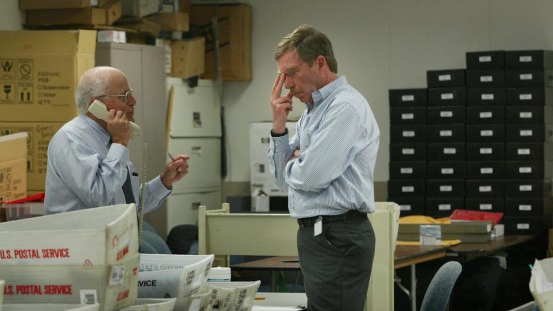 Miami-Dade Elections Department supervisor David Leahy, right, with First Assistant County Attorney Murray Greenberg, left, in the tabulation room at the elections department in the county government building in downtown Miami. They were wrapping up a recount of District 39 Senate race votes on Friday, September 13, 2002.