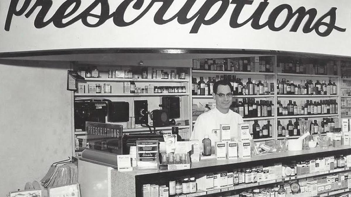 Dr. Paul Pesce and his wife Eleanor opened their corner drugstore Paul’s Drugs, a neighborhood mainstay for more than three decades until its sale in the mid-1980s. Pesce ran the pharmacy, his wife grew the business to include a Western Union, post office, beauty shop and ice cream fountain.