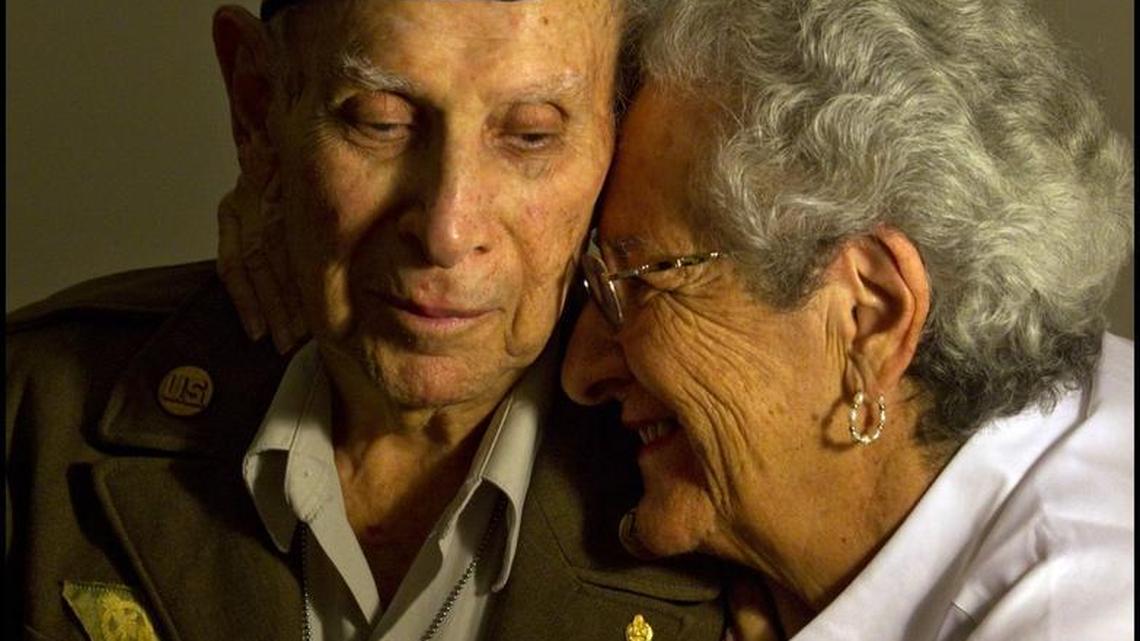 George Katzman was a World War II veteran who lived in Aventura. Here, he is pictured just shy of 94 years old. Katzman was wearing his 70-year-old uniform (“It still fits!”), when he and his wife Ellen (at right), were having lunch at Olive Garden in Plantation with their daughter Susan in November 2013. On their way out, they discovered that someone had paid for their meals.