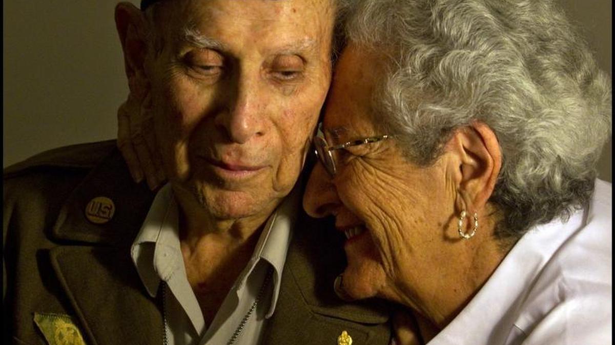 George Katzman was a World War II veteran who lived in Aventura. Here, he is pictured just shy of 94 years old. Katzman was wearing his 70-year-old uniform (“It still fits!”), when he and his wife Ellen (at right), were having lunch at Olive Garden in Plantation with their daughter Susan in November 2013. On their way out, they discovered that someone had paid for their meals.