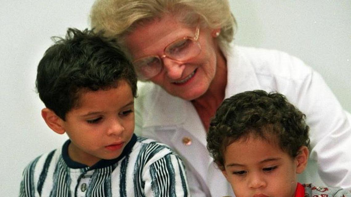 At the UM/Jackson Clinic, Dr. Nancy Fawcett was known for her learned approach to pediatrics and her ability to comfort children and their parents. Here, in this July 20, 1998 file photo, she reads to Ali Velasquez, then-5, and brother Alex Velasquez, then-2 for a Reach-out & Read program.