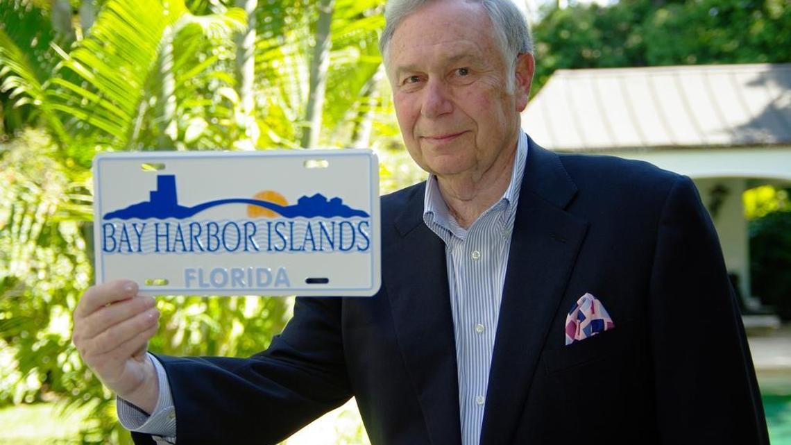 Morris Broad, son of the founder of Bay Harbor Islands, held one of the town’s commemorative licenses plates he helped finance in 2010. He is seen at his Coral Gables home in 2010.