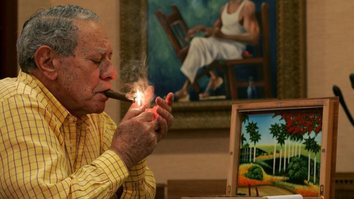 Jose Orlando Padron lights up a cigar at Padron Cigars headquarters at 1575 SW First St. as the company celebrated its 40th anniversary in Miami in 2004.
