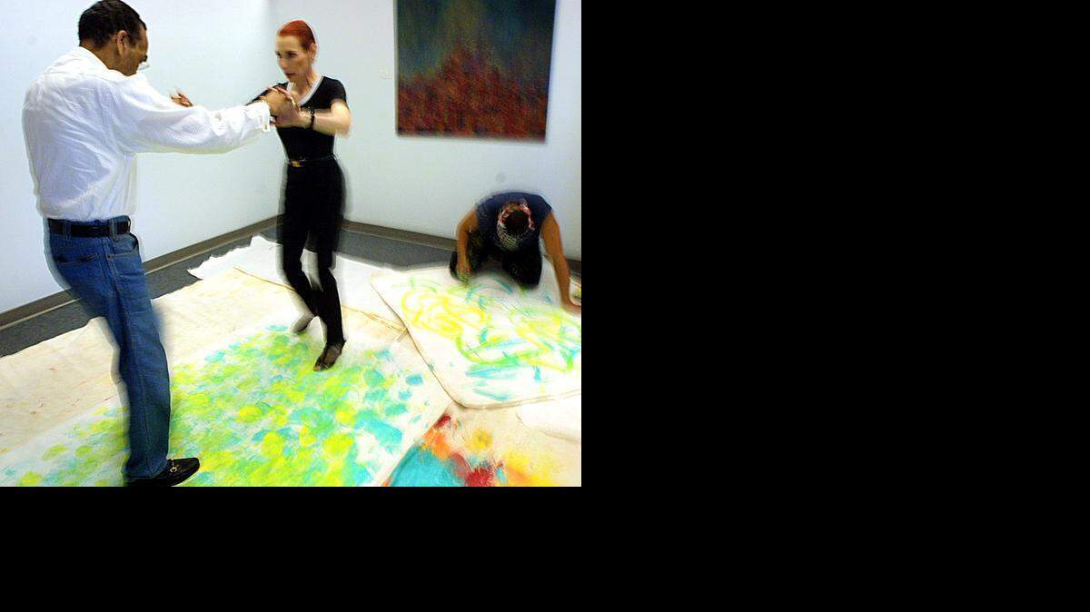 
FEET ON EXHIBITION: The original ‘Mambo King,’ Pedro Aguilar, also known as Cuban Pete, danced with partner Barbara Craddock as artist Erich Padilla painted their moves on canvas at the Byron-Carlyle Arts Center in Miami Beach on July 17, 2002. Padilla, working for the International Latin Music Hall of Fame, used a wooden clave dipped in paint to capture the dance pros’ footsteps for an exhibit.
