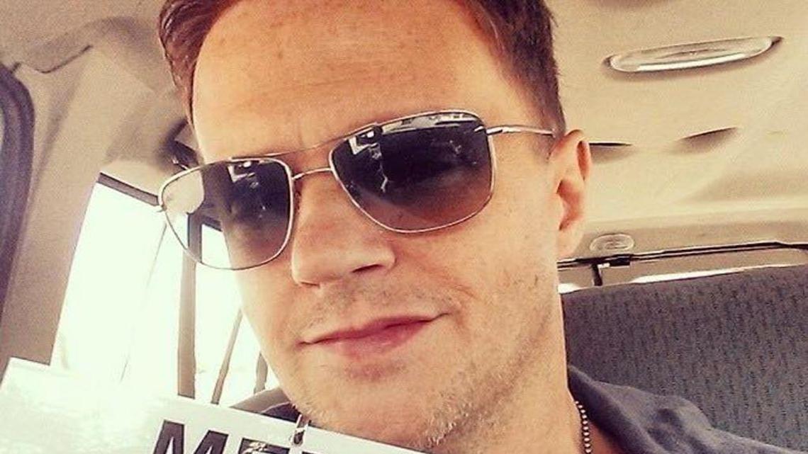 Chez Pazienza holds the fake media pass that The Daily Banter online news/opinion site made for him to cover the Ferguson protests after the fatal shooting of Michael Brown by a white police officer on Aug. 9, 2014, in Ferguson, Missouri.