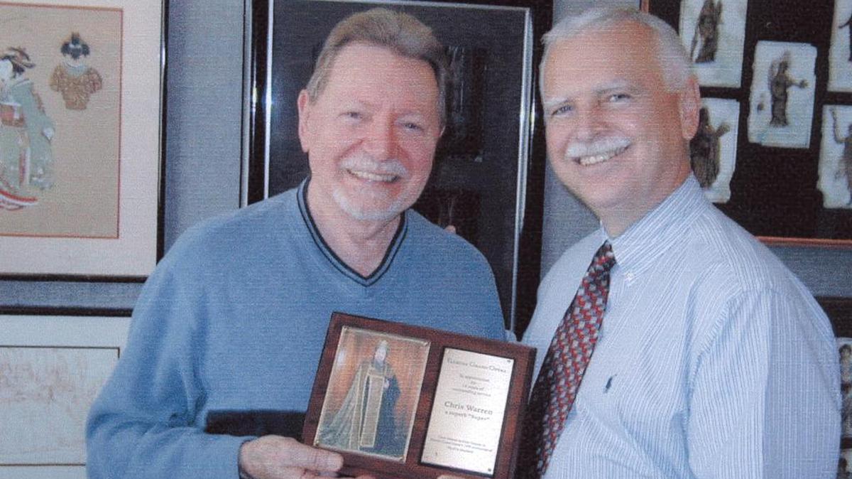 On June 23, 2002, Robert Heuer (right), General Manager of Florida Grand Opera, presented Chris Warren with a plaque of appreciation for 14 years of outstanding service with the opera company.