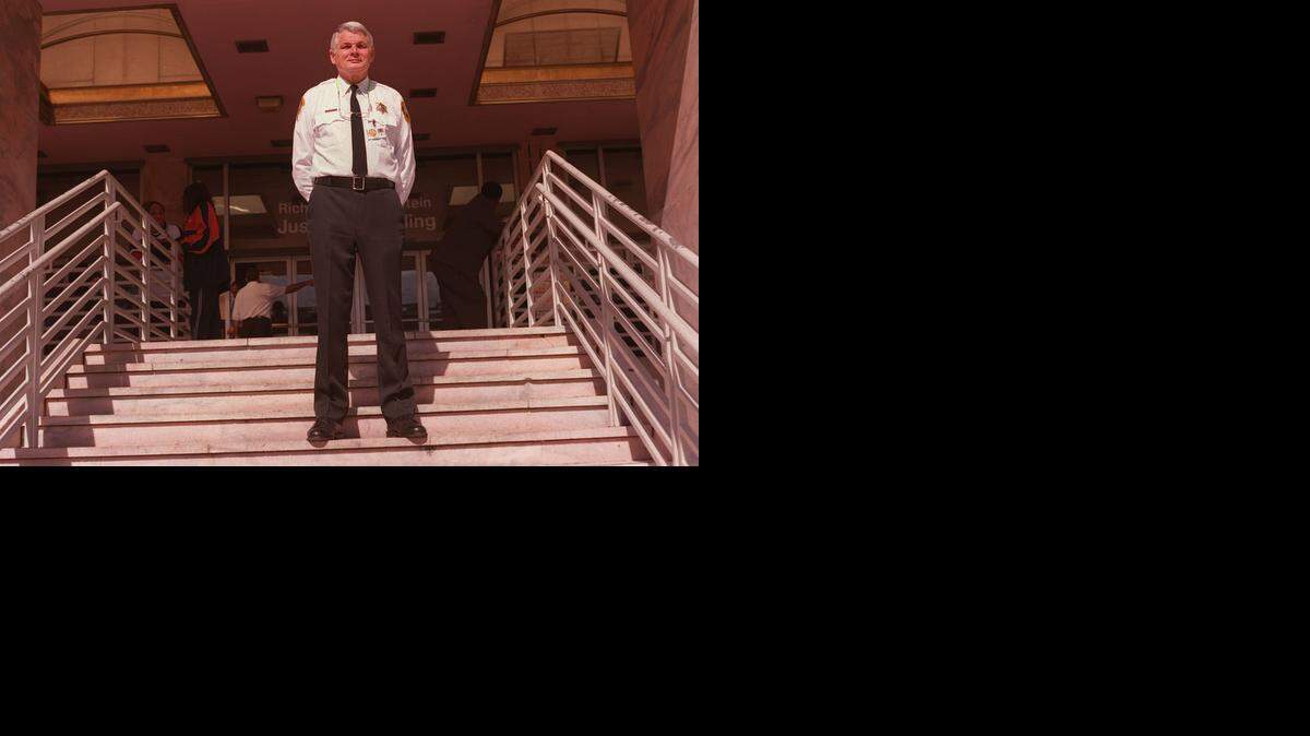 
BAILIFF: Mark Reno, brother of U. S. Attorney General Janet Reno, is seen here in January 2000 when he was a bailiff at the Miami-Dade Justice Building. Reno would keep a roll of paper towels with him to comfort people who burst into tears upon sentencing.
