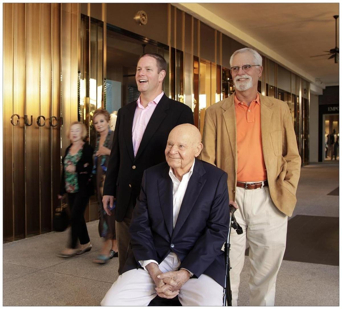 Three generations of Whitmans: grandson, Matthew Whitman Lazenby, left, Stanley Whitman, and son, Randy Whitman, right, by the Gucci storefront at Bal Harbour Shops in 2013.