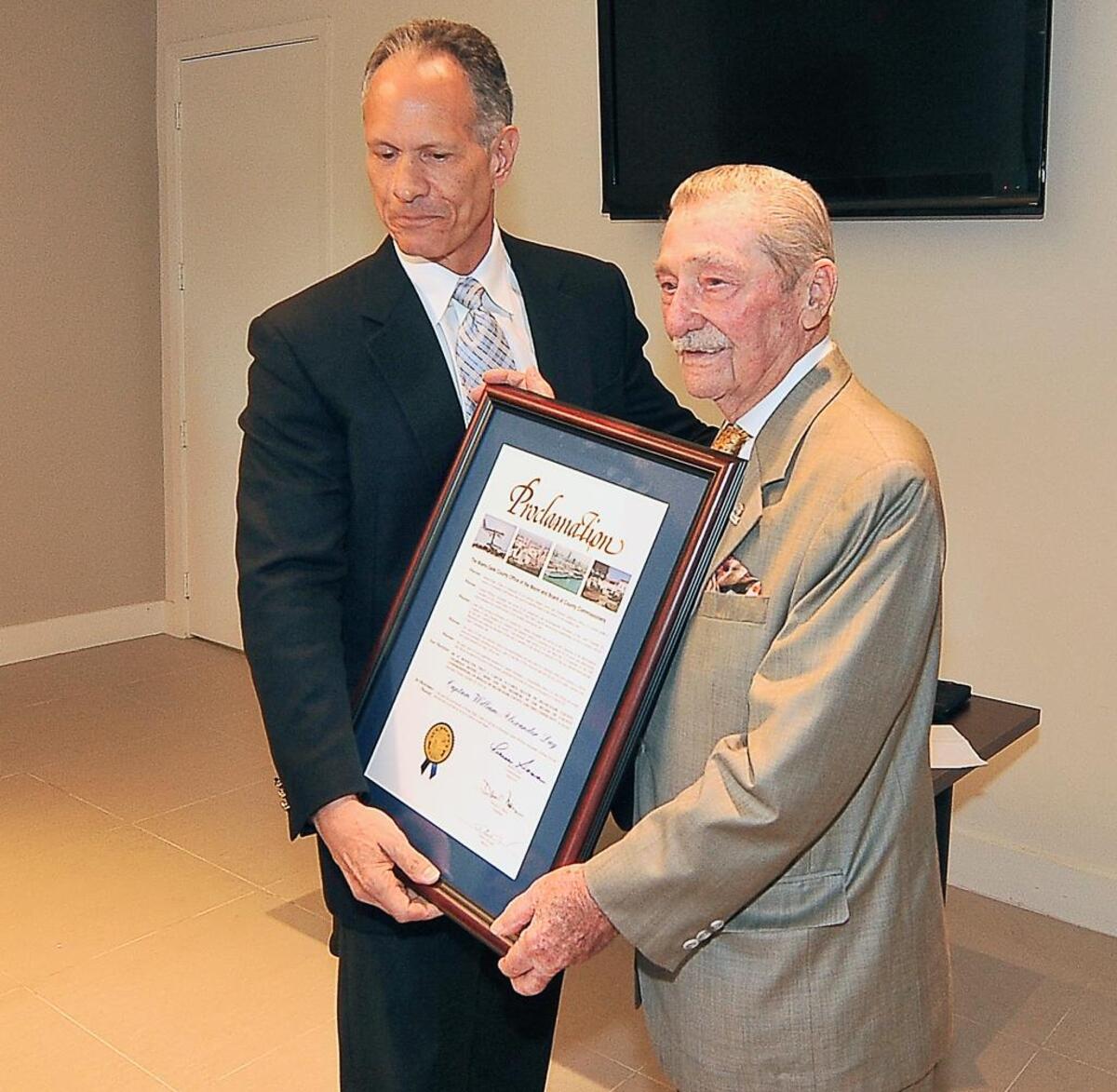 In this Oct. 29, 2010 file photo, then-Miami-Dade Mayor Carlos Alvarez gave a proclamation to retiring CAMACOL president William Alexander (right) at a luncheon in Miami