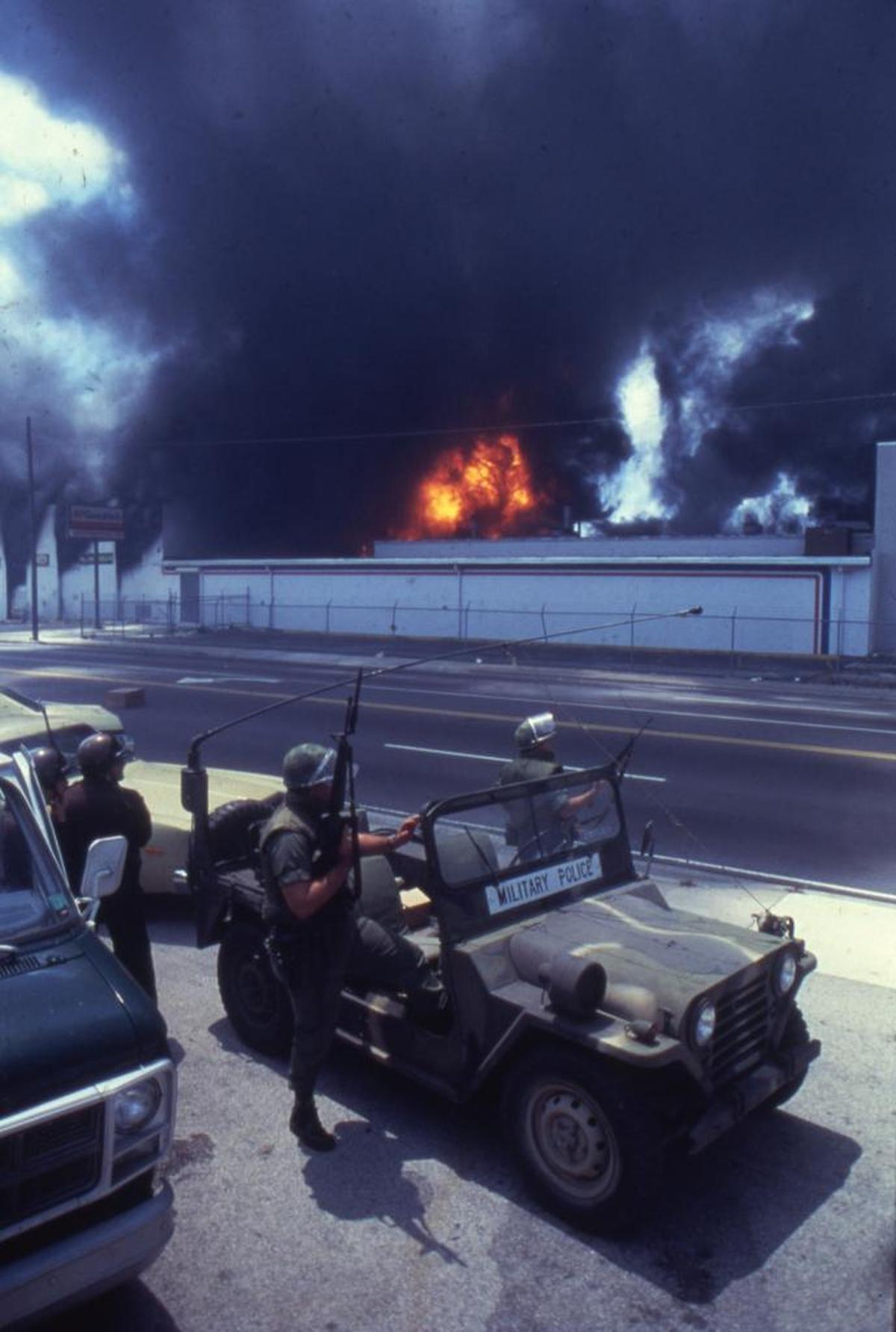 Guardsmen took position across from the burning Norton Tire Co. on May 18, 1980. Smoke from the building at Northwest 27th Avenue and 54th Street filled the Miami skyline.