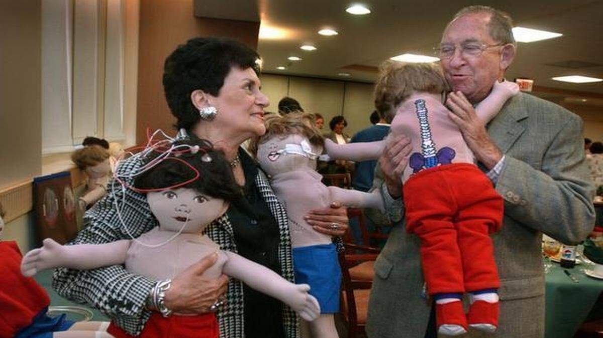 
DOLLS: Bunchy Gertner (left) and Kirk Landon cuddle some teaching dolls that will be used by the Pediatric Patient Education Enhancement Project at Jackson Memorial Hospital in 2001. The dolls were presented at a special luncheon in the new Diagnostic Treatment Center. Gertner is head of the "Babes in the Woods" fund and Landon donated $30,000 dollars to the fund in order to purchase the dolls which will be used by doctors, nurses and social workers to explain various procedures to children and their families and help to alleviate some of the fears of their illness. 
