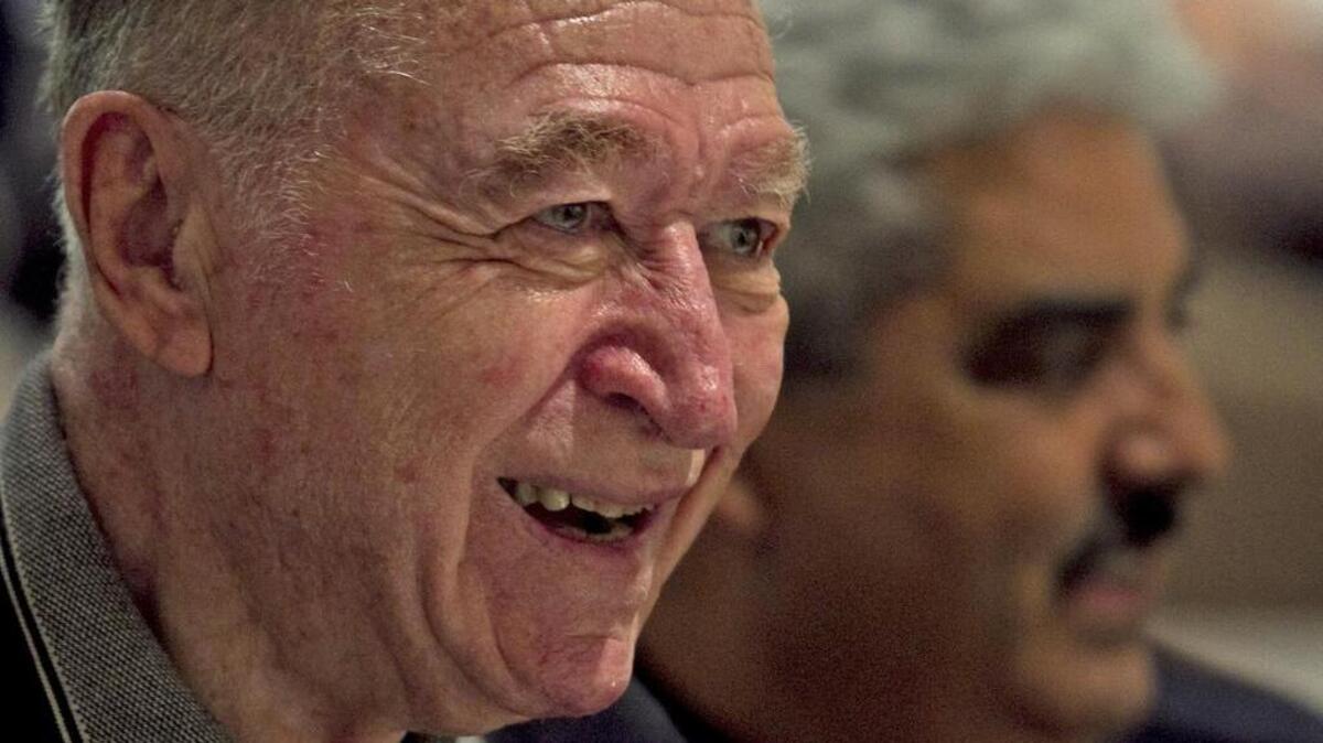 Attorney Irving Whitman, left, a retired city of Miami police detective, laughs with then-police chief Miguel Exposito during a 2011 ceremony. The event, held at the Miami Police College Auditorium in Miami, commemorated past and present members of the Miami Police Homicide Unit by listing their names on a plaque.