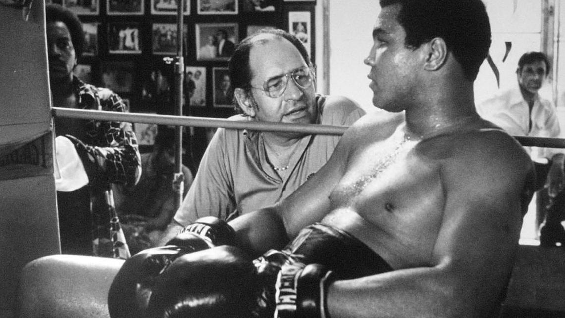 Luisita Sevilla-Pacheco’s photo from the 1970s of Dr. Ferdie Pacheco, the Fight Doctor, talking to Muhammad Ali. The photo was shot in the 5th Street Gym in Miami Beach, during the filming of ‘The Greatest.’
