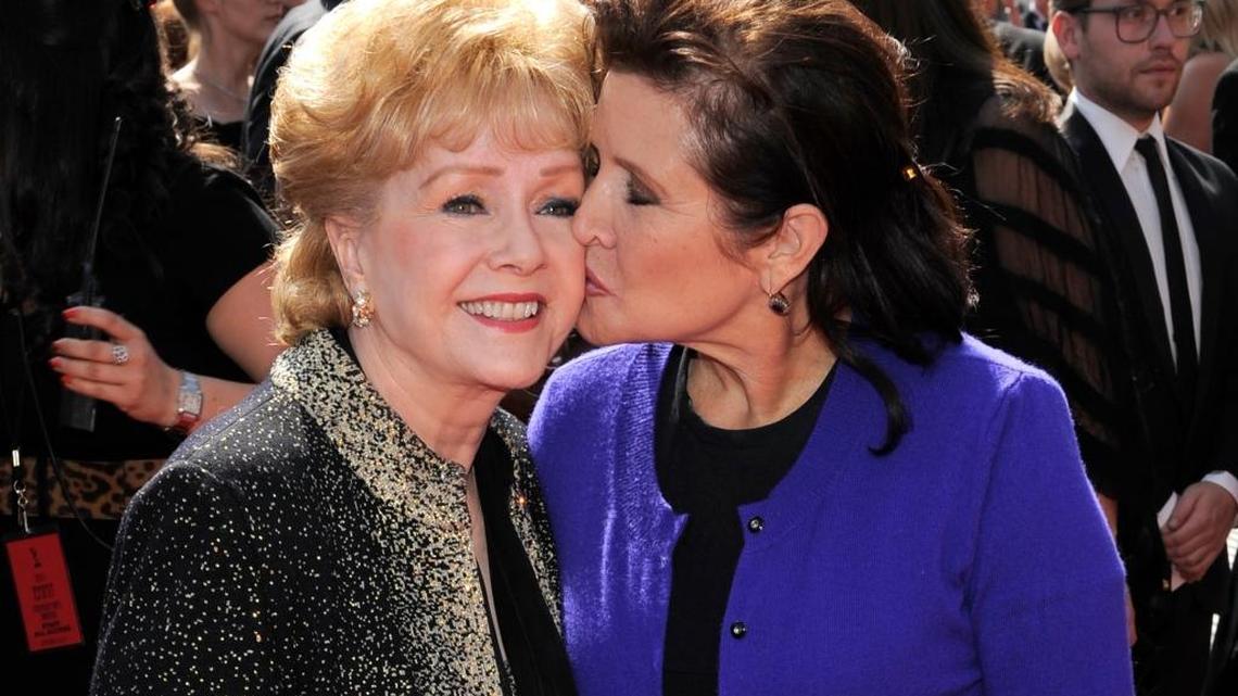 In this Sept. 10, 2011, file photo, Debbie Reynolds, left, and daughter Carrie Fisher arrive at the Primetime Creative Arts Emmy Awards in Los Angeles. Mother and daughter died within a day of one another.