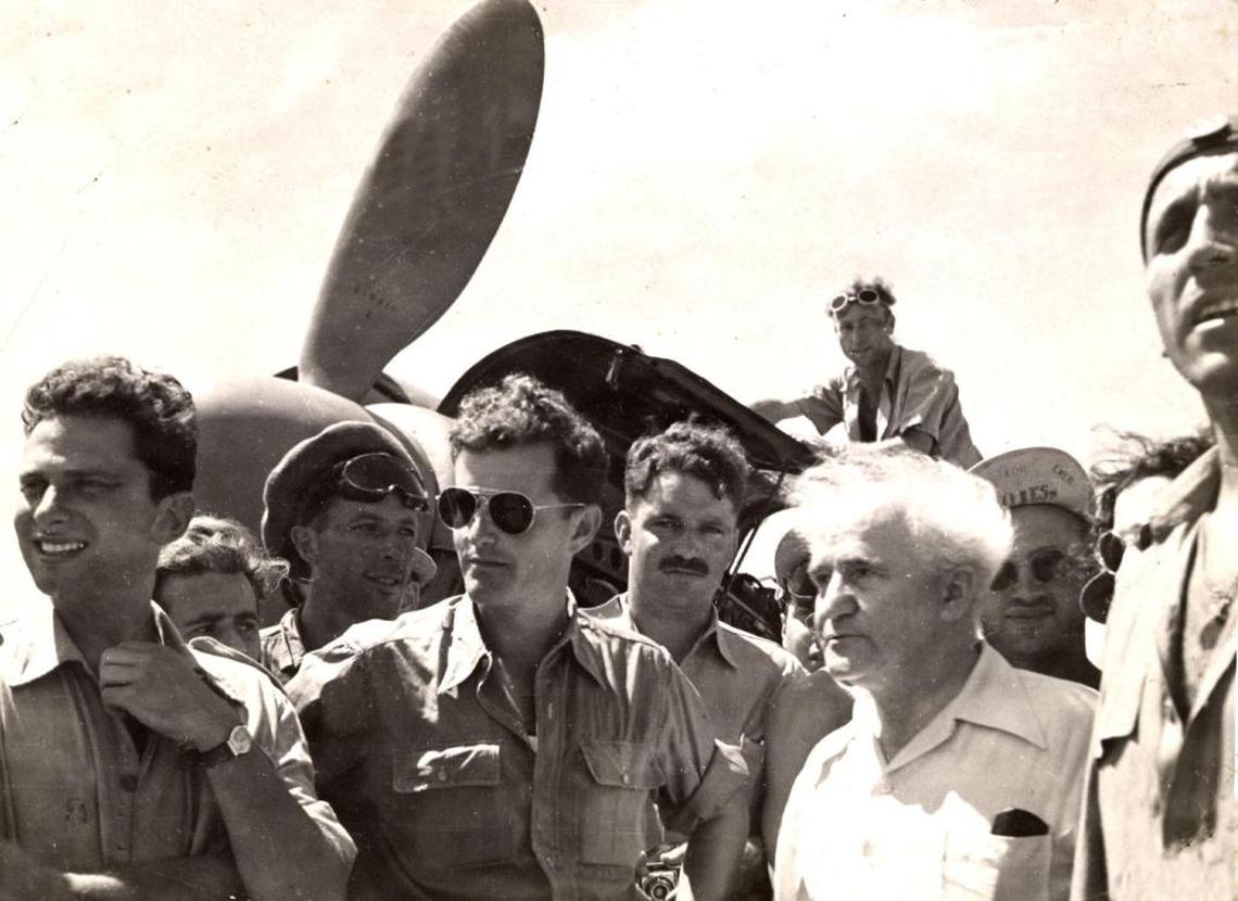 Historical photo from Gideon Lichtman, left, standing in front of one of the Messerschmitts he flew for the Israeli Air Force in 1948. At right, with white hair, is David Ben-Gurion, Israel’s first prime minister.