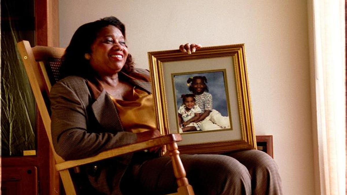 
FAMILY FIRST: In 1995, Francena Thomas, born in Miami on March 23, 1936, worked in the community relations department of Miami-Dade Police. For a Miami Herald feature on grandparents, she is pictured holding a portrait of her grandchildren Samantha Baker, then 2, and Kiana Thomas, then 9. On the wall behind Thomas is a portrait of her grandmother Teannan Bingham Townsend who died in 1948.
