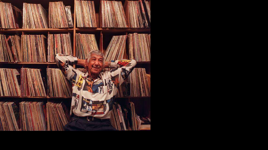 
WALL OF SOUNDS: China Valles, then 74 in July 2000, had recently left WTMI after they changed their format. But he never left his music. He’s seen here in front of only part of his collection of jazz LPs.
