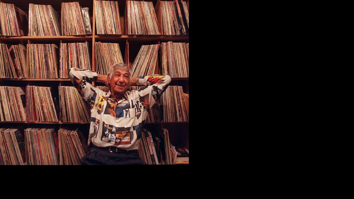 
WALL OF SOUNDS: China Valles, then 74 in July 2000, had recently left WTMI after they changed their format. But he never left his music. He’s seen here in front of only part of his collection of jazz LPs.
