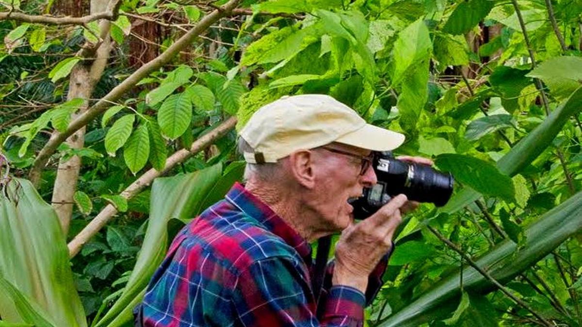 Architect Henry Alexander won numerous honors in his field. But his other great passion was photography. Here, in a photo taken by his sister-in-law Gail Rieke, he shoots at The Kampong in Coconut Grove in January 2017. He was a docent at The Kampong and at the Lowe Art Museum at University of Miami.
