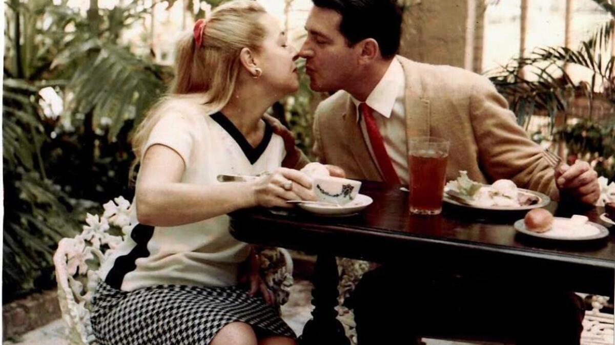 Lady Anna Lee Porter and husband Sir Edward Porter share a kiss on the patio of their North Bay Road home in December 1965.