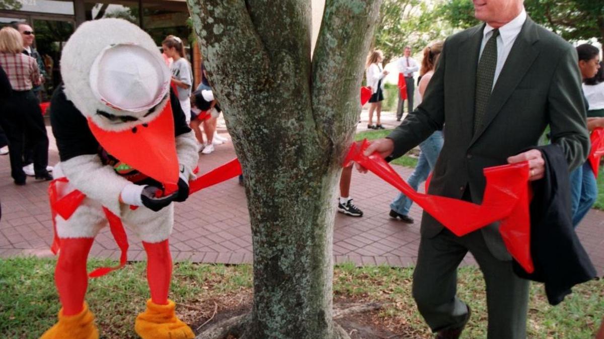 The University of Miami Ibis helped UM President Edward “Tad” Foote tie a ribbon around a tree in front of the Hecht Athletic Center to raise awareness of responsible student behavior at an event in 1997. Foote served the UM from 1981 to 2001.
