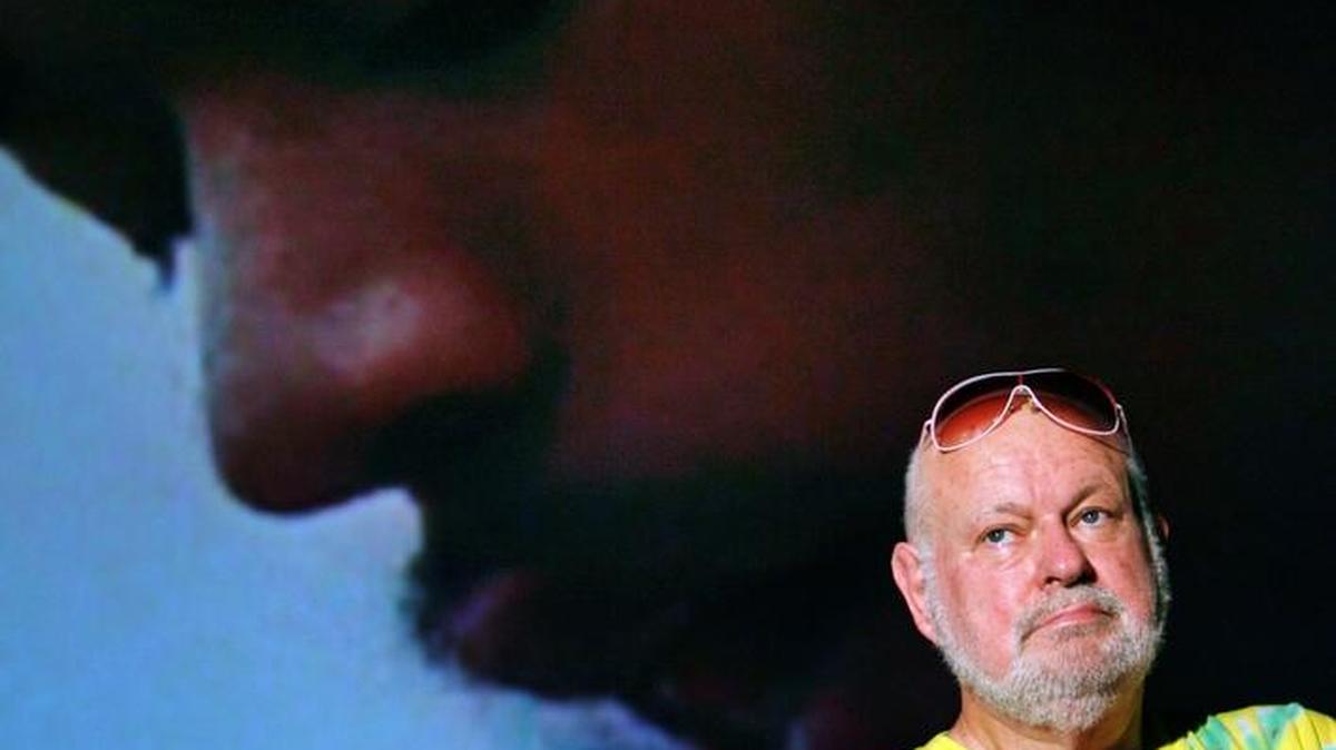 Elliot Tiber, who is credited with enabling Woodstock, was photographed at Cinema Paradiso in Fort Lauderdale on March 12, 2008. In the background, an image of rocker Jimi Hendrix from the 1970 film, "Woodstock."