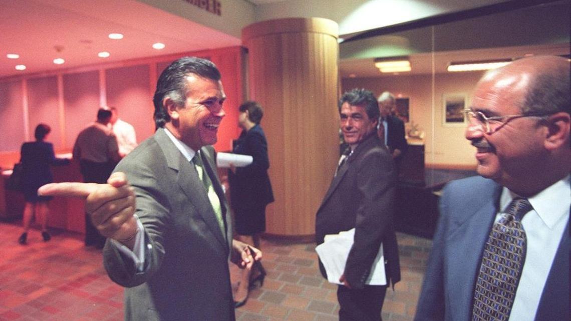 Sergio Pereira, left, and Chris Korge, far right, joke together outside the commission chambers in 2006 during a Miami-Dade County Commission meeting.