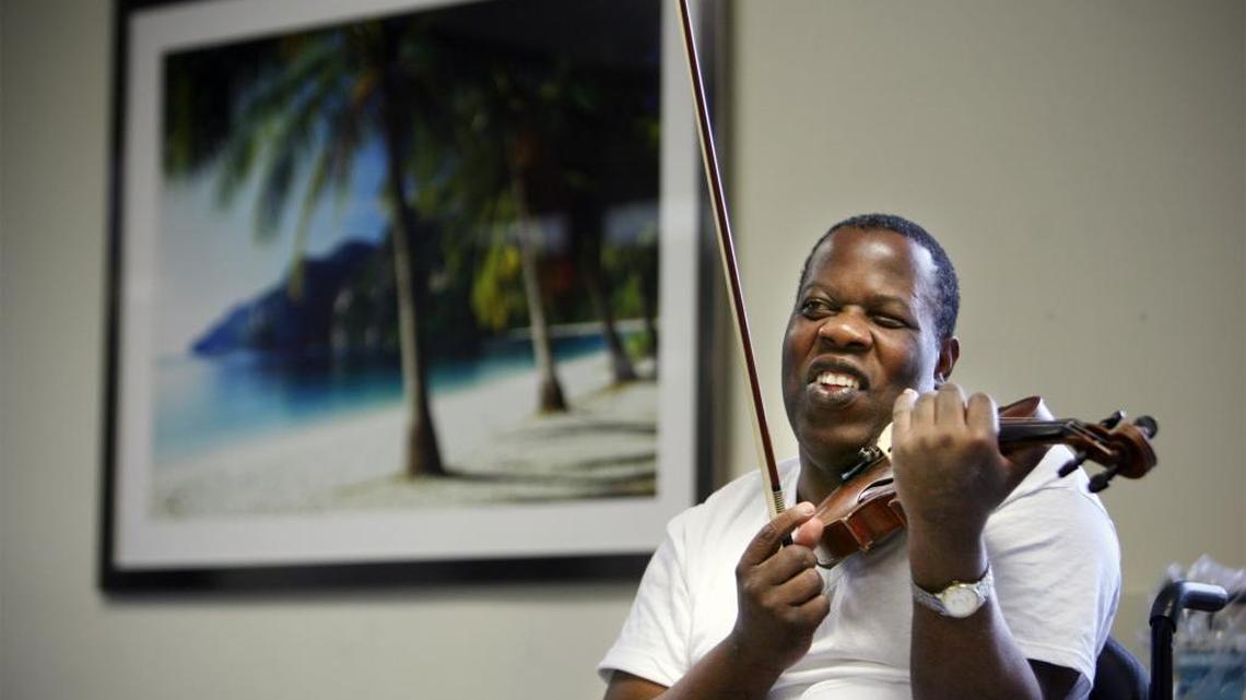 
Romel Joseph, a blind violinist who survived the January 2010 earthquake in Haiti after spending 18 hours pinned under concrete, played the violin at the rehabilitation center at Jackson Memorial Hospital in March 2010, just a few months after treatment.
