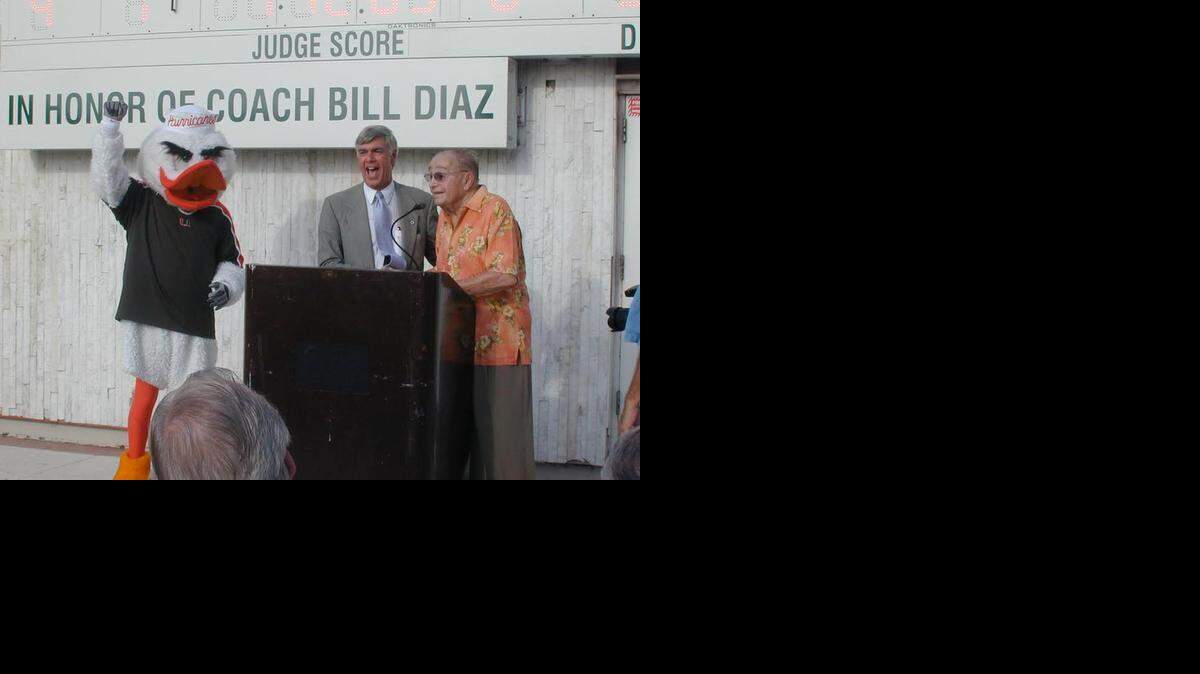 
HONORS: University of Miami Head Swimming Coach Bill Diaz (right) is honored with a scoreboard on the pool deck at the UM. Diaz is a UM Hall of Fame inductee.
