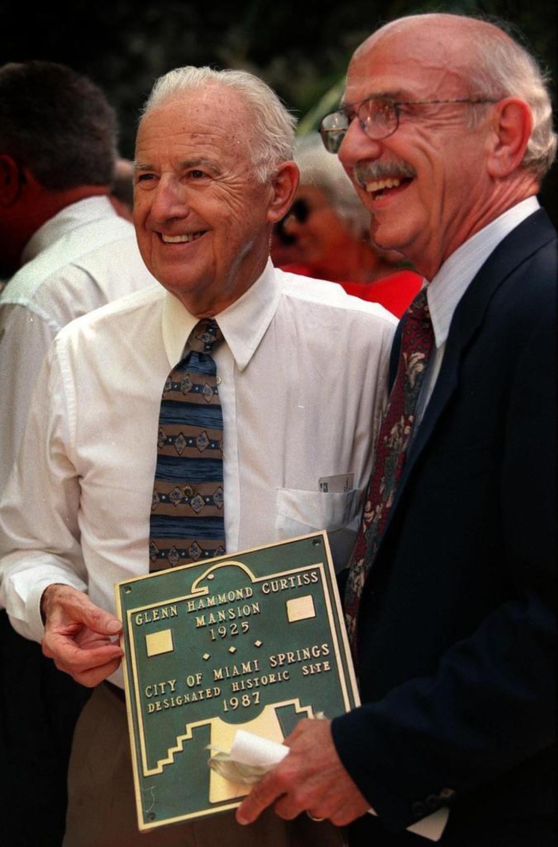 In this Aug. 26, 1998, file photo, John Stadnik (left), then president of the Historic Preservation Board of Miami Springs, and Miami Springs Mayor John Cavalier, shared a historical designation plaque at the Curtiss Mansion in Miami Springs.