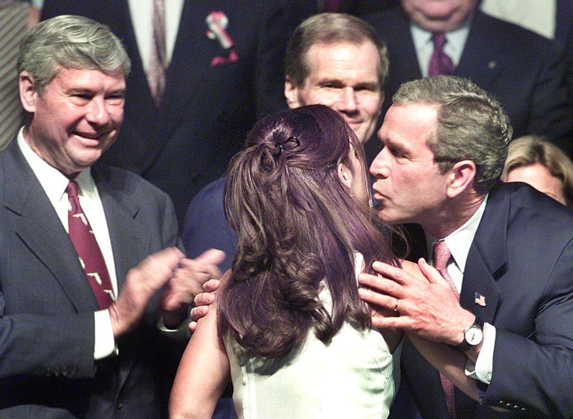 President George Bush kisses Gloria Estefan at the Knight Center during his visit in 2002. Estefan sang the Cuban national anthem. Senators Bob Graham and Bill Nelson looked on in this file photo.