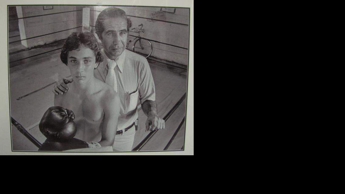 
A photo of Dr. Menelaos “Mickey” Demos and his son, Mickey Jr., taken in Coconut Grove in 1979, that now hangs on the wall of the son’s boxing gym in Miami.
