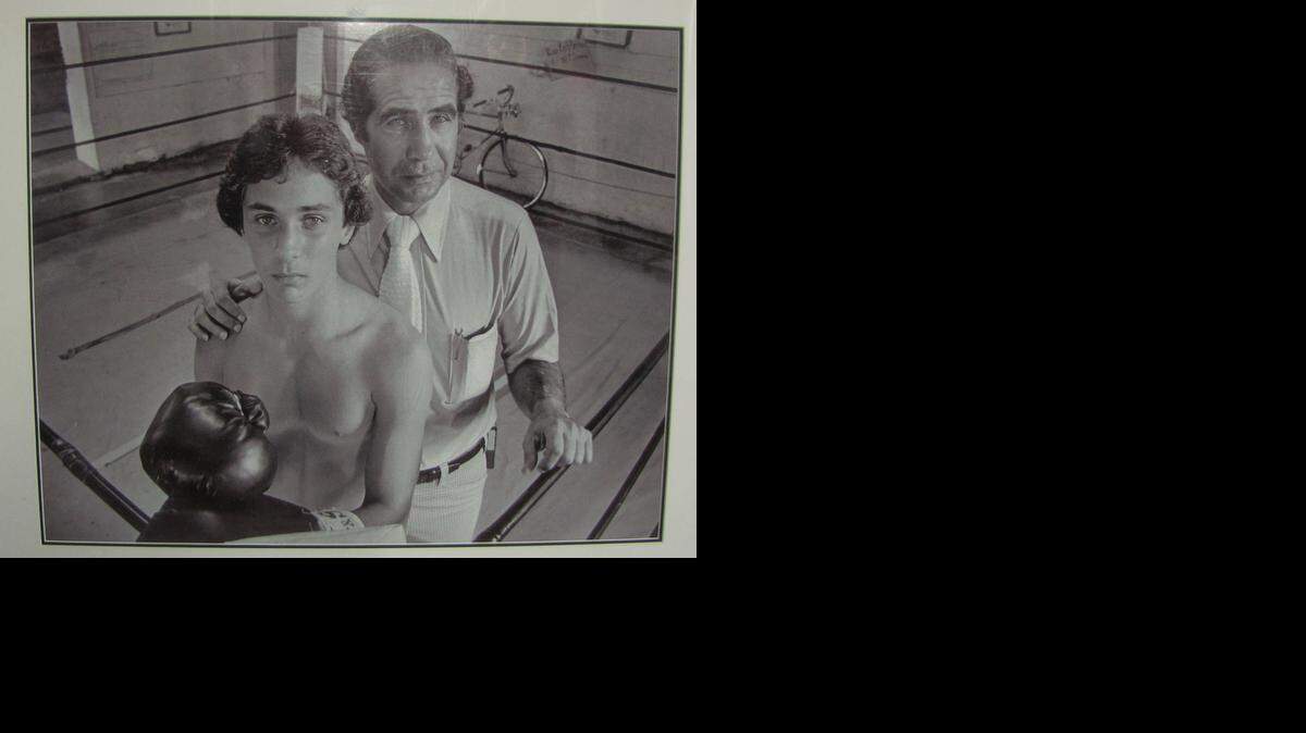 
A photo of Dr. Menelaos “Mickey” Demos and his son, Mickey Jr., taken in Coconut Grove in 1979, that now hangs on the wall of the son’s boxing gym in Miami.
