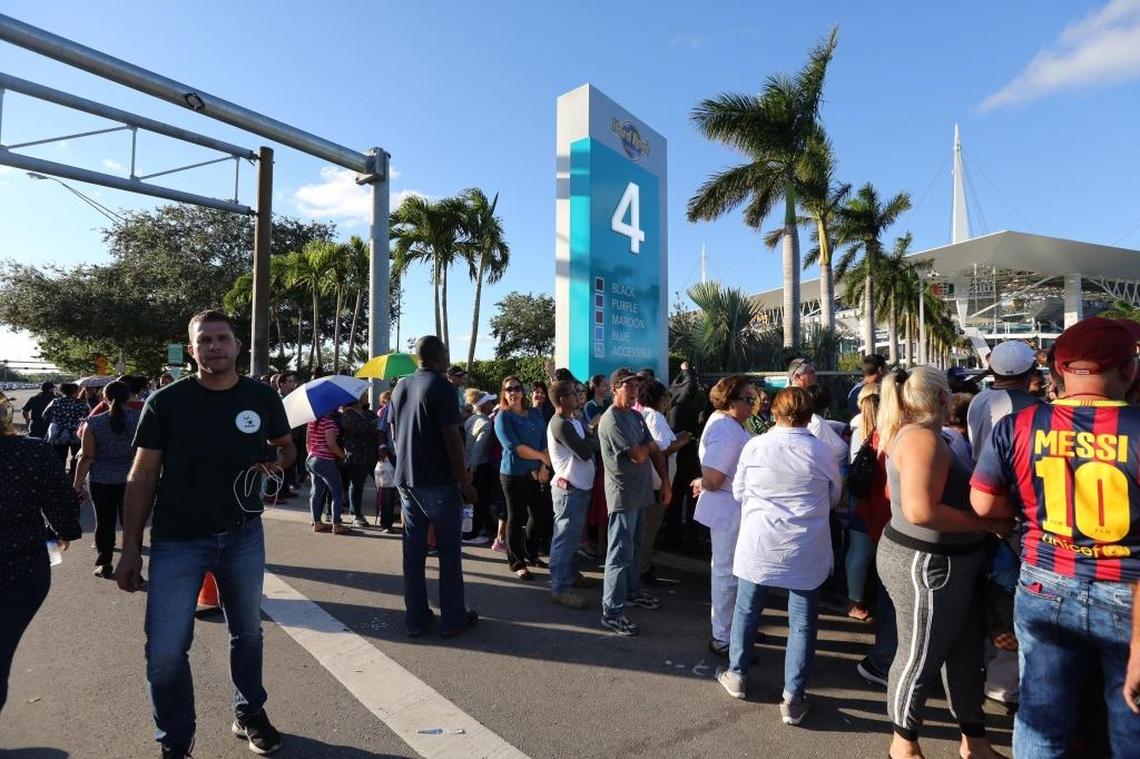 Hundreds line up outside of Hard Rock Stadium after being denied entrance once the stadium was closed due to full capacity for food assistance money