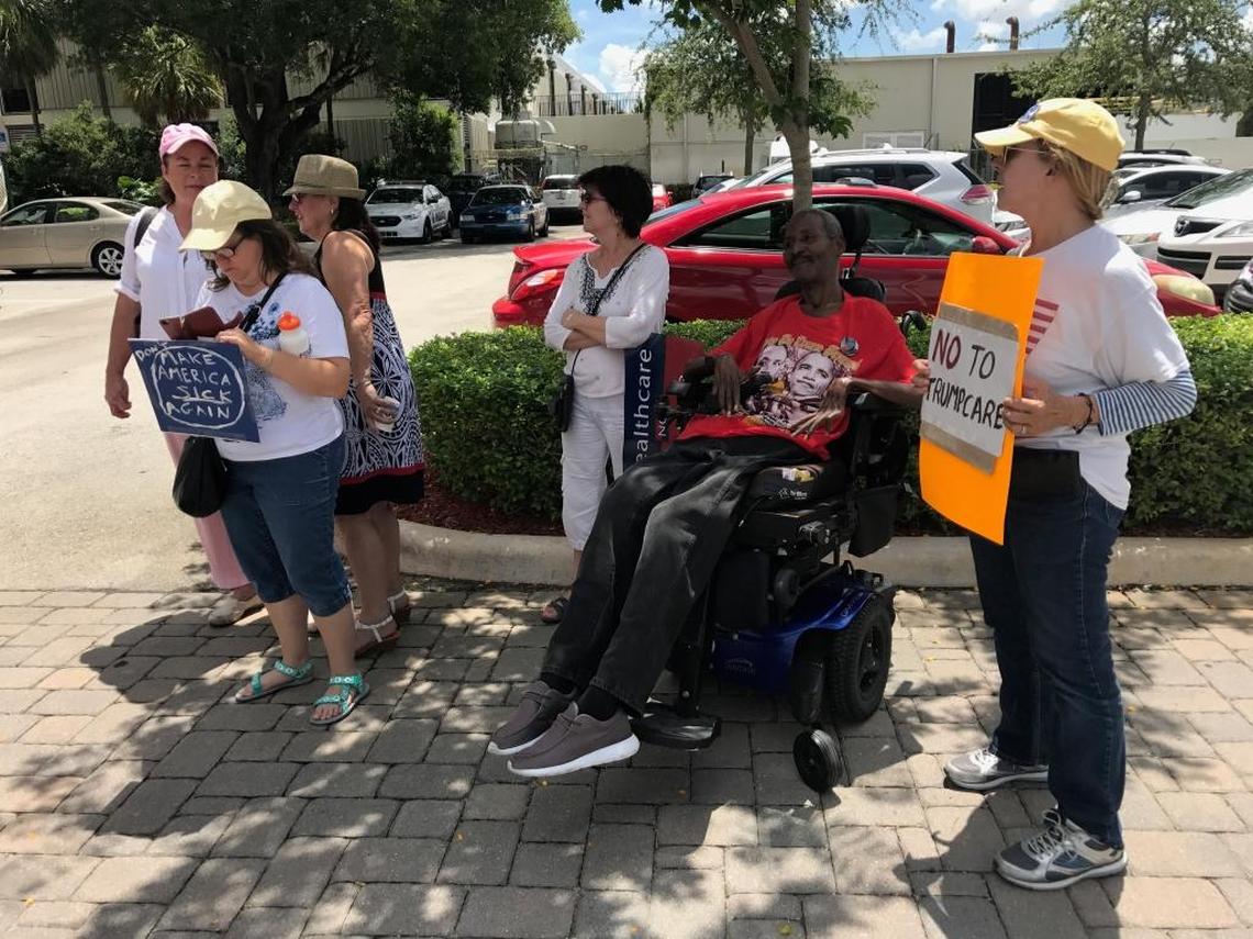 Ronald Fulton, 54, sits among other protesters, catching a spot of shade in front of Sen. Marco Rubio’s Doral office on July 18, 2017. Fulton was one of 40 protesters who showed up at Rubio’s office, despite the Senate’s latest replacement bill failing.